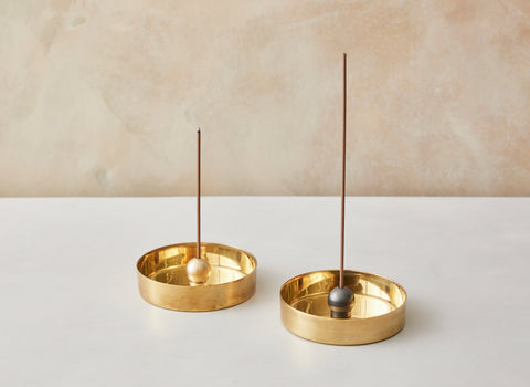 A charming modernist design, the brass sphere (available in natural brass or black patina ) sits upon a ring allowing you to pivot the incense in any direction.