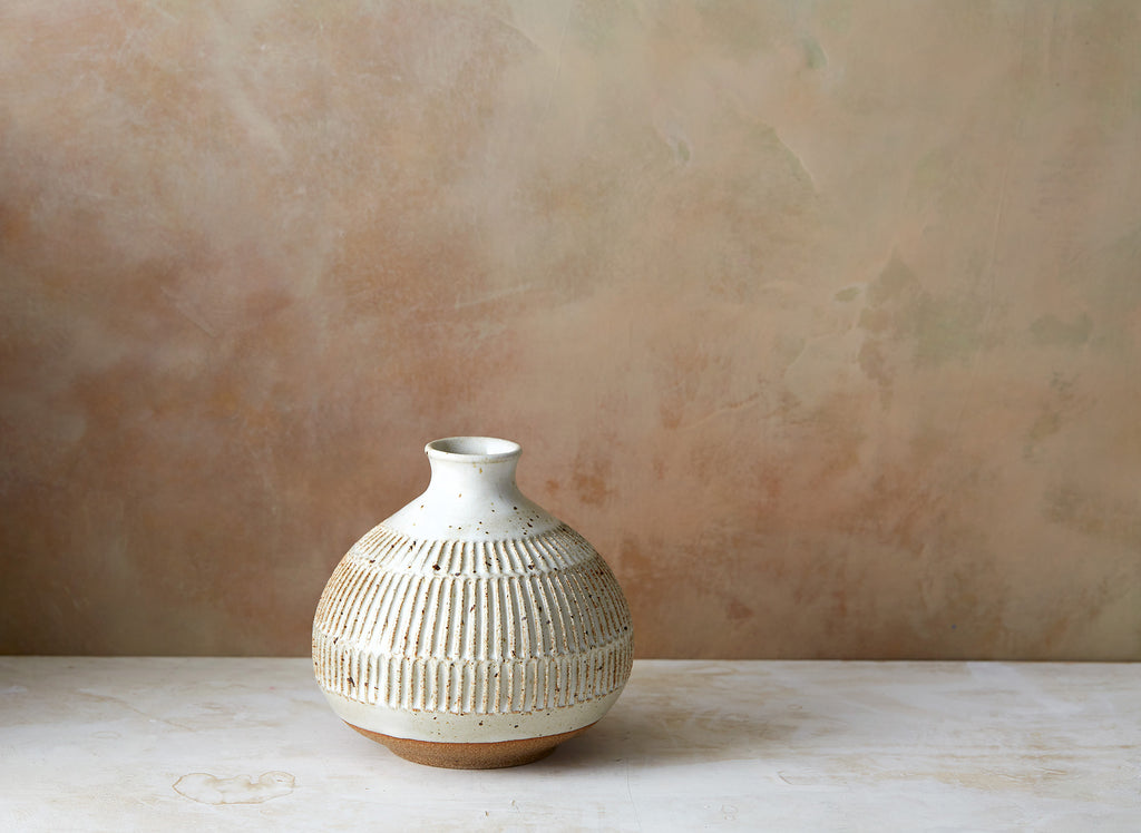 Beautiful hand thrown tulip vase with pinched neck, lipped opening and notches carved into the body. Glazed in white with brown speckles, from Mt. Washington Pottery.