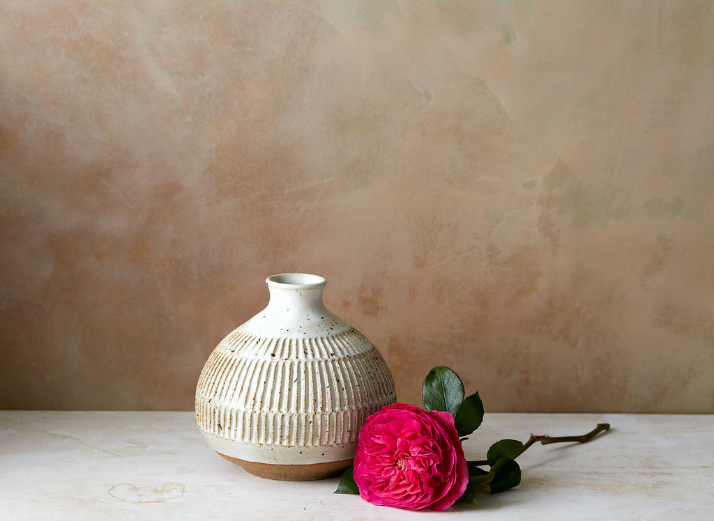 Beautiful hand thrown tulip vase with pinched neck, lipped opening and notches carved into the body. Glazed in white with brown speckles, from Mt. Washington Pottery.