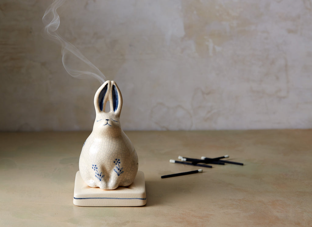Shop our incredibly charming rabbit incense holder at BELLOCQ. Made of white porcelain with a light crackle glaze and blue details. 