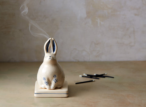 Shop our incredibly charming rabbit incense holder at BELLOCQ. Made of white porcelain with a light crackle glaze and blue details. 